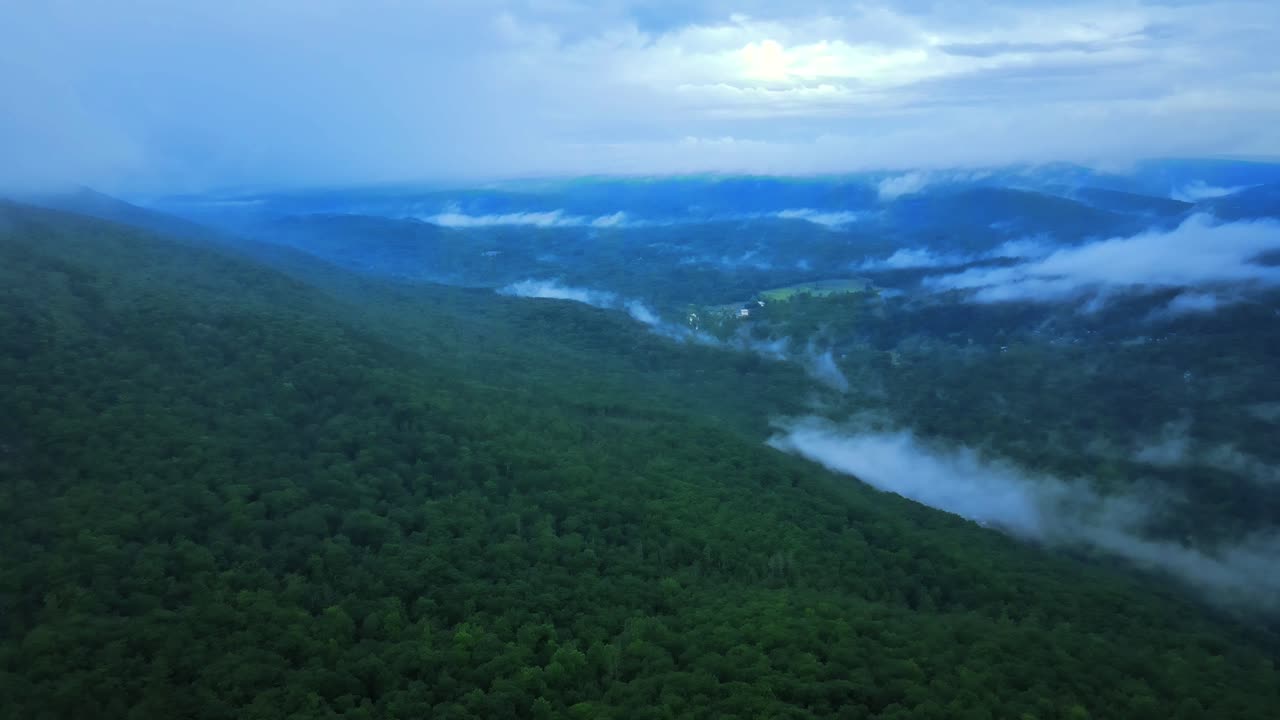 Aerial drone video footage of low clouds over the Appalachian mountains during a summer evening. This is in New York's Hudson Valley on Shawangunk Ridge, which is a sub-range of the Appalachians.