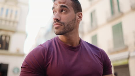 young man texting on smartphone outdoors.