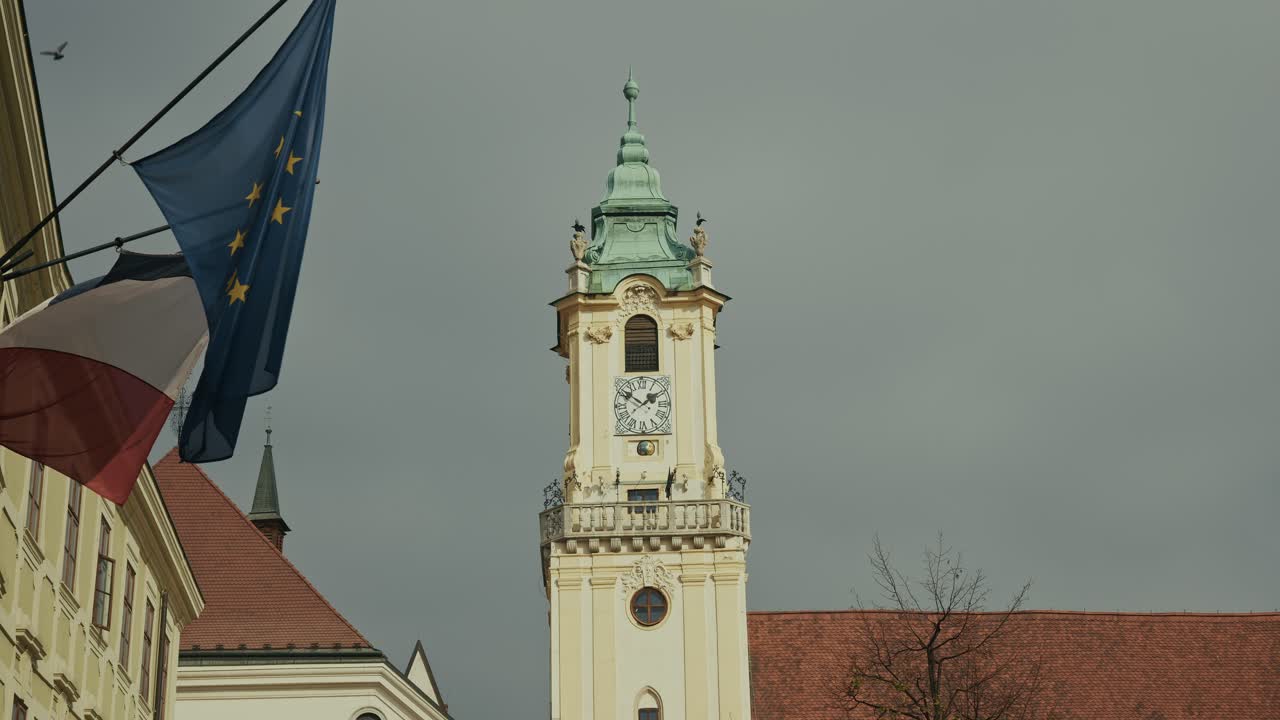 Bratislava Old Town Hall tower framed by the European Union flag in the wind