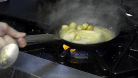 fresh agnolotti pasta in frying pan with parsnips and potatoes medium shot