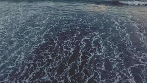 Rocky-beach-sea-shore-and-splashing-waves-aerial-view