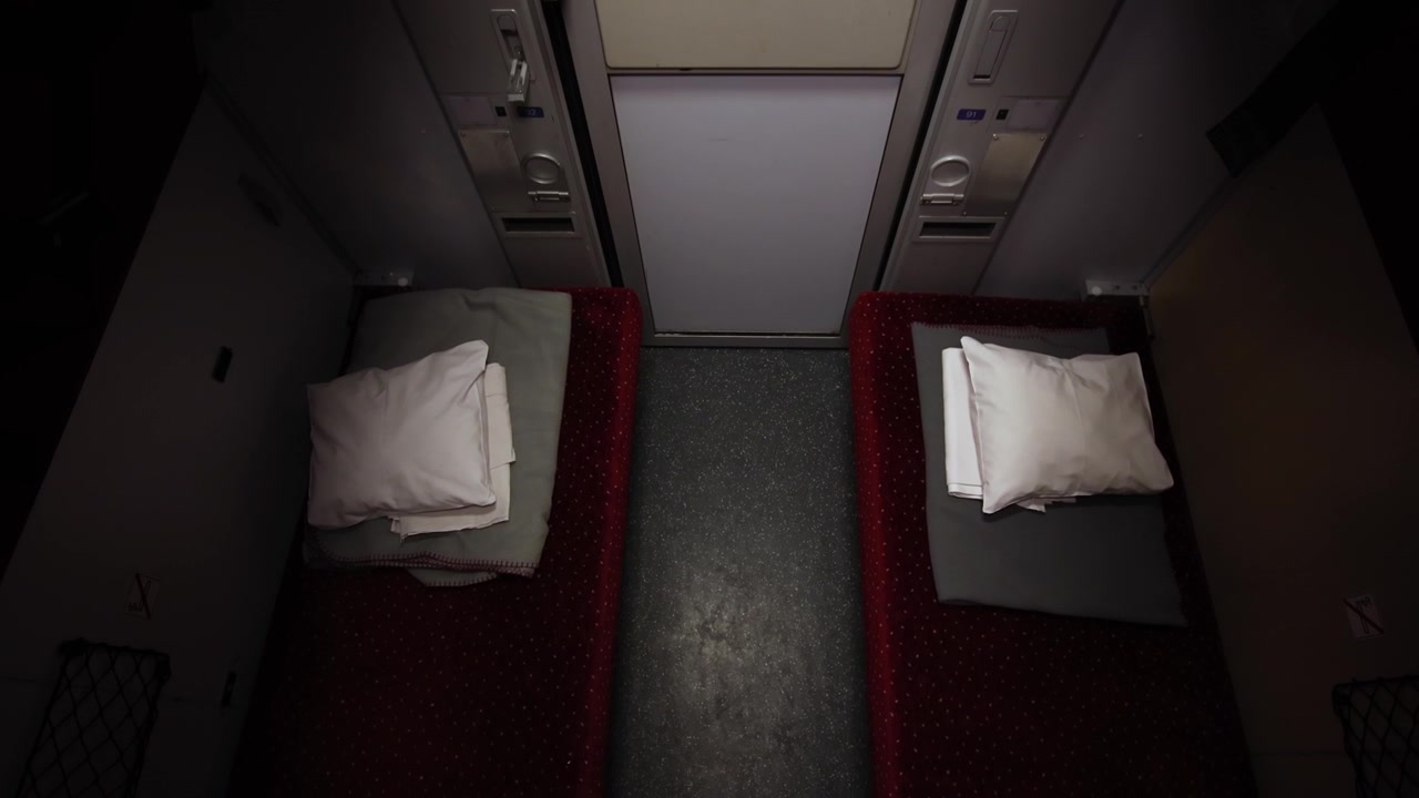 Beds on a moving night train, top down view establisher