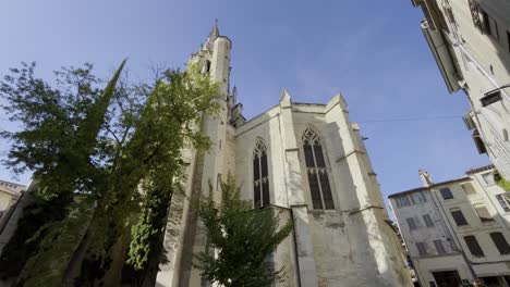 imposing church in avignon france in a city in good weather