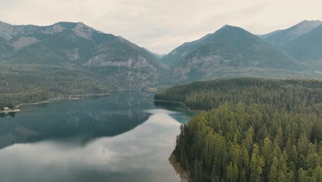 peaceful mountain lake with forest reflections over clear water