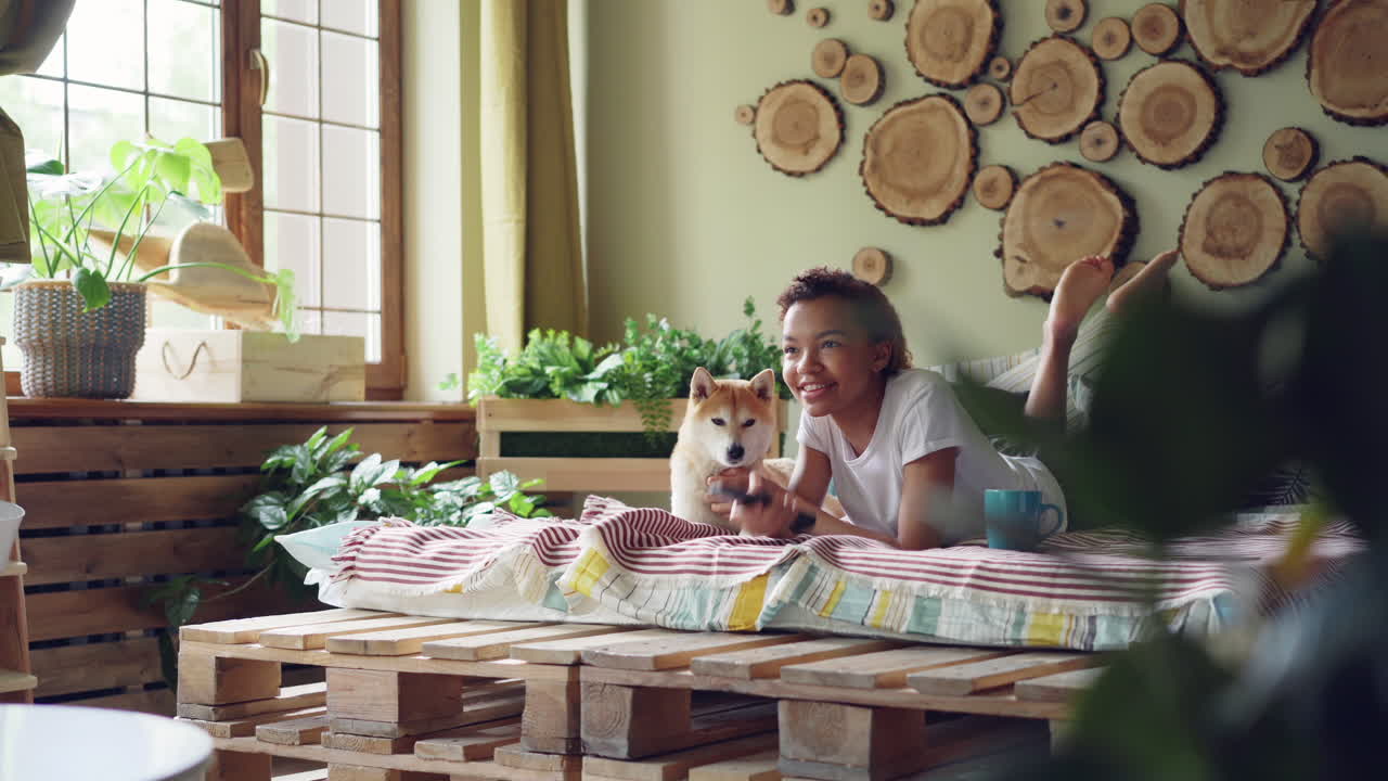 Young woman relaxing with dog at home