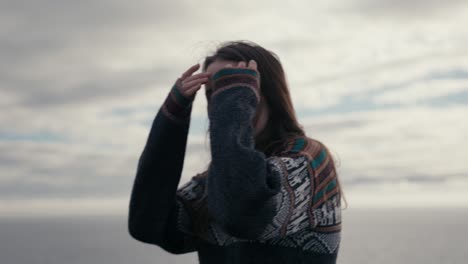 A-cute-girl-walks-along-the-beach-in-slow-motion-and-smiles-at-the-camera