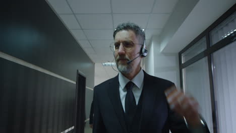 businessman on phone call in office corridor