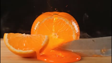 cutting a glowing orange with a knife