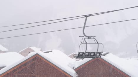 lonely chairlift in the middle of a snowstorm in a ski resort in the mountains