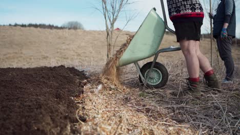 Man-Using-Garden-Wheelbarrow-In-The-Farm---Close-Up