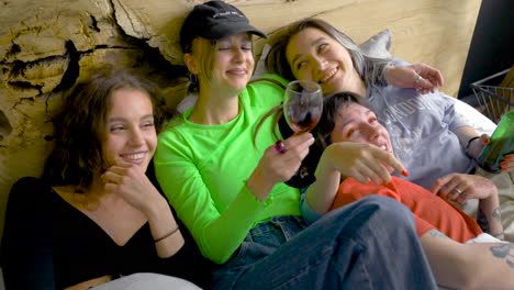 Girl-Friends-Laughing-And-Talking-While-Two-Of-Them-Drink-Alcohol