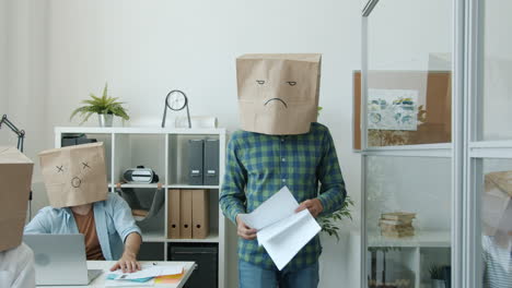 funny office scene with paper bags on heads