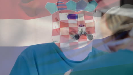 animation of flag of croatia over caucasian surgeons during surgery