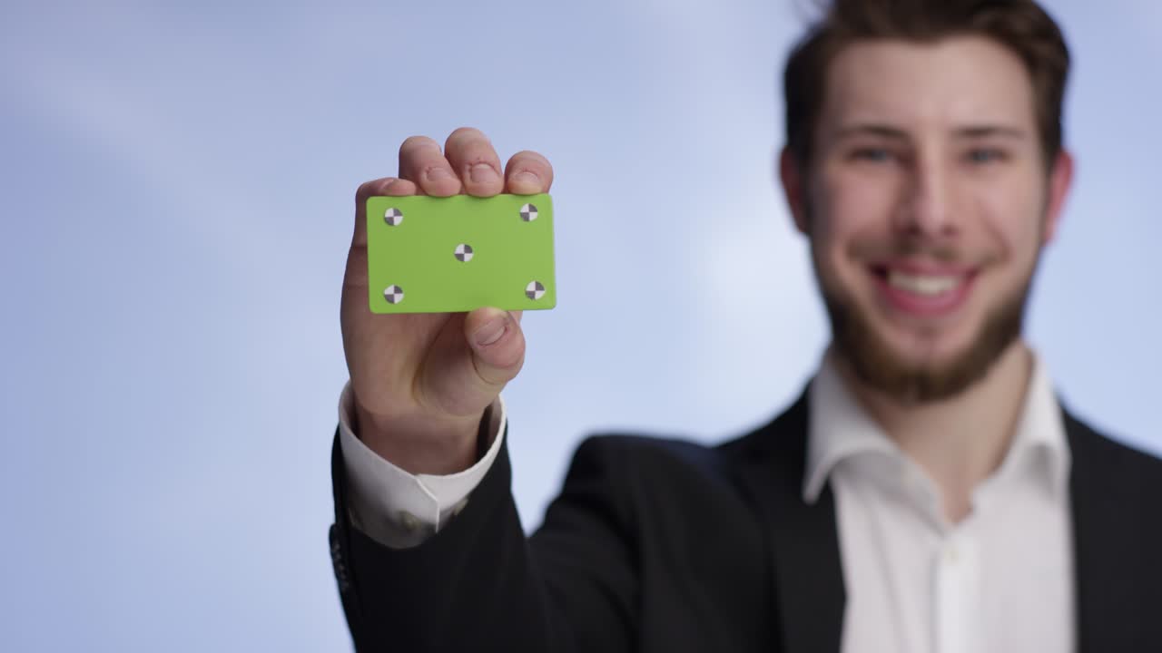 Attractive man showing your buisness card into the camera