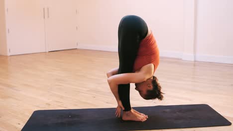 Woman-performing-standing-forward-bend