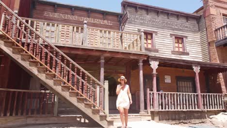 girl walks the stairs at oasis mini hollywood (western theme park and film set) in the tabernas desert in almeria, andalucia, spain