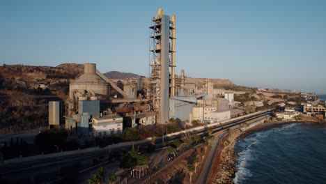 Aerial-view-showing-industrial-factory-at-coastline-of-Malaga-during-golden-sunset