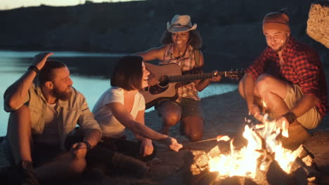 group of friends camping near a lake
