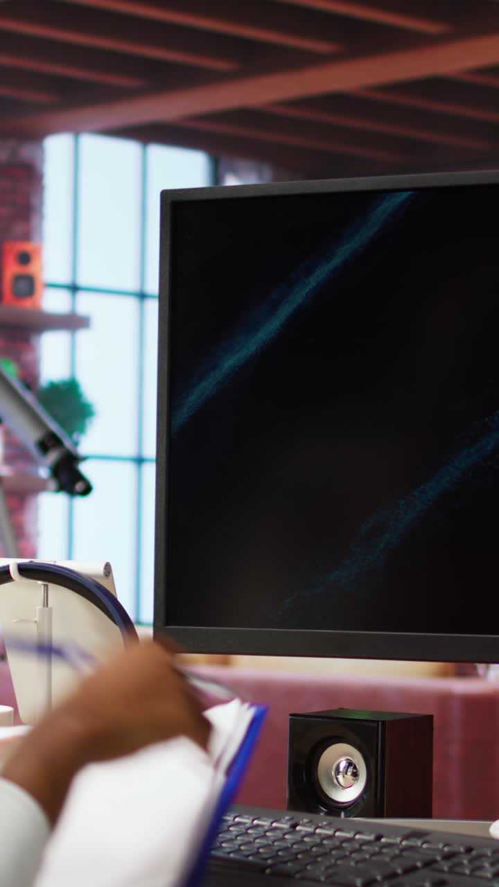 Vertical video Remote worker at home watching business conference on PC, checking paperwork