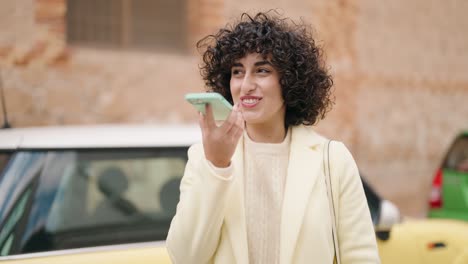 young woman smiling confident talking on the smartphone at street