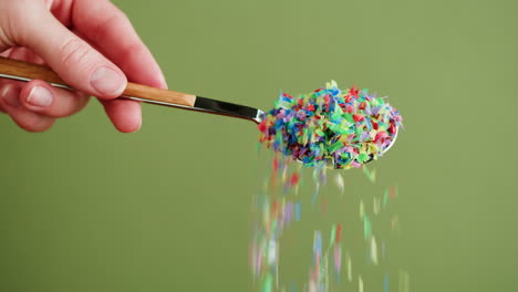 colorful sprinkles falling from a spoon