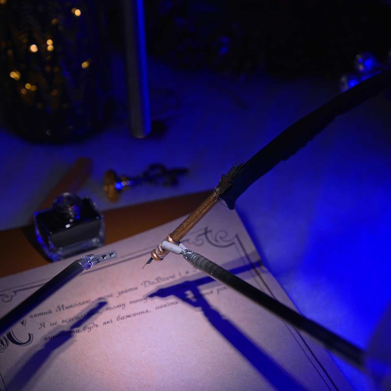 Delicate high-precise robotic forceps holding old-fashioned writing pen over the paper. Christmas decorations at backdrop in dark surgery room