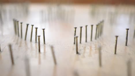 close up on pinball table made of wood. the glass beads roll down on the pinball table. a game played by a child.