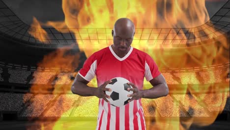 animation of stadium and flames over african american male soccer player