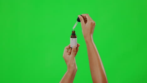 Hands,-beauty-and-woman-with-serum-on-green