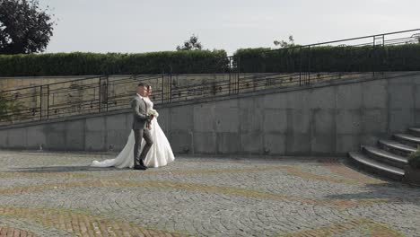 Lovely-newlyweds-caucasian-bride-groom-walking-in-park,-holding-hands,-wedding-couple-family