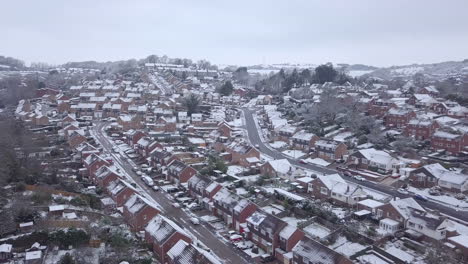 low dolly forward drone shot of snowy exeter subburbs crop