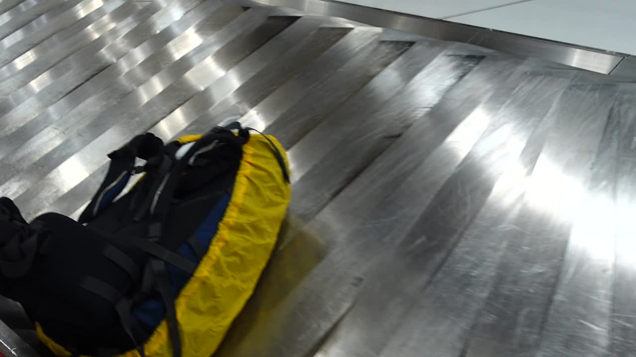 Receiving baggage at the airport. Passengers are waiting for their luggage after arrival