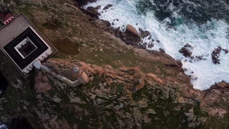 Vista-Aérea-De-Pájaro-Del-Faro-Con-La-Roca-Del-Acantilado-Oceánico-Y-Las-Olas-Rompiendo,-España-Región-Norte-De-La-Costa-De-Galicia