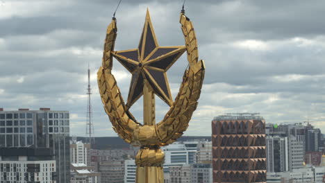 golden star on a building rooftop with city view