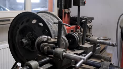 close-up of a wheel rim repair machine in operation