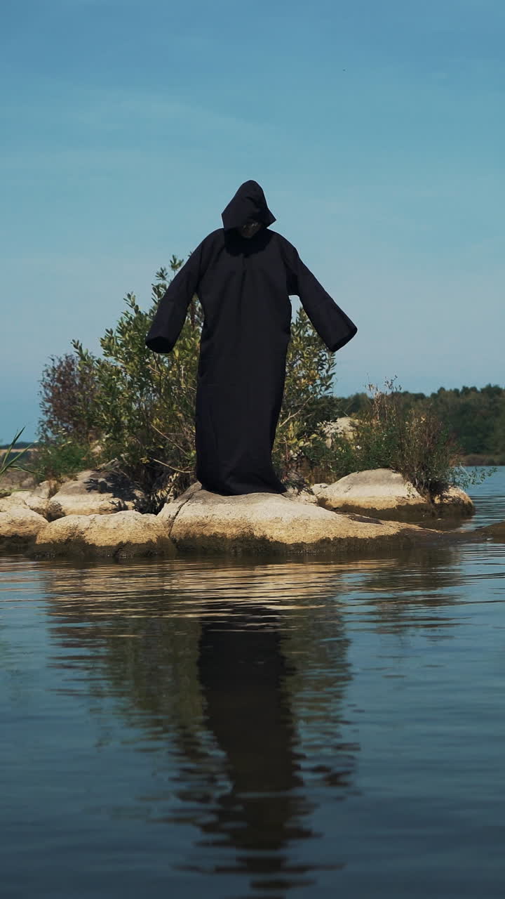 Terrible witch on the river bank. Mysticism of Halloween Vertical video