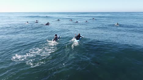 surfers paddling out to the break