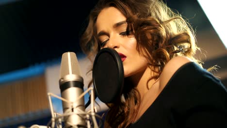 beautiful young singer who recorded a song in a professional recording studio.