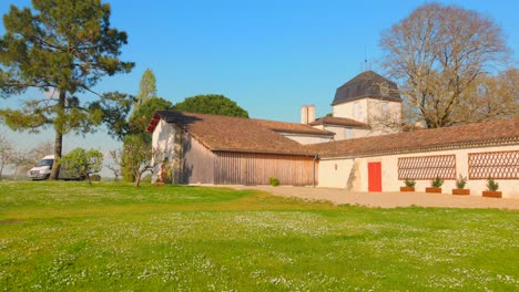 discover the tranquil beauty of francois mauriac's house in malagar, france, surrounded by lush greenery. the scene showcases stunning architecture against a clear blue sky, conveying peacefulness