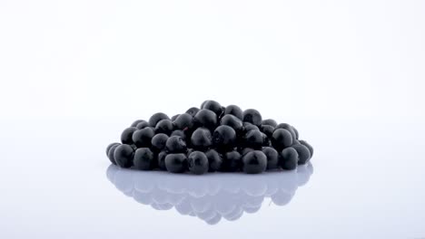 heap of blueberries rotating on the on the turntable isolated on the white background. close up.
