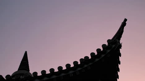 silhouette of a temple roof at sunset