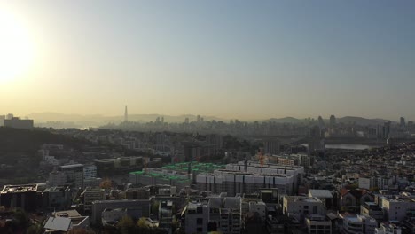 Flying-over-city-in-Seoul-Korea-early-in-the-morning-with-the-sunrise-and-Han-river-in-the-distance