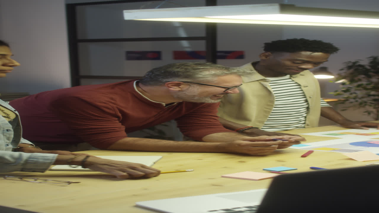 Business Team Working on Project in Office at Night