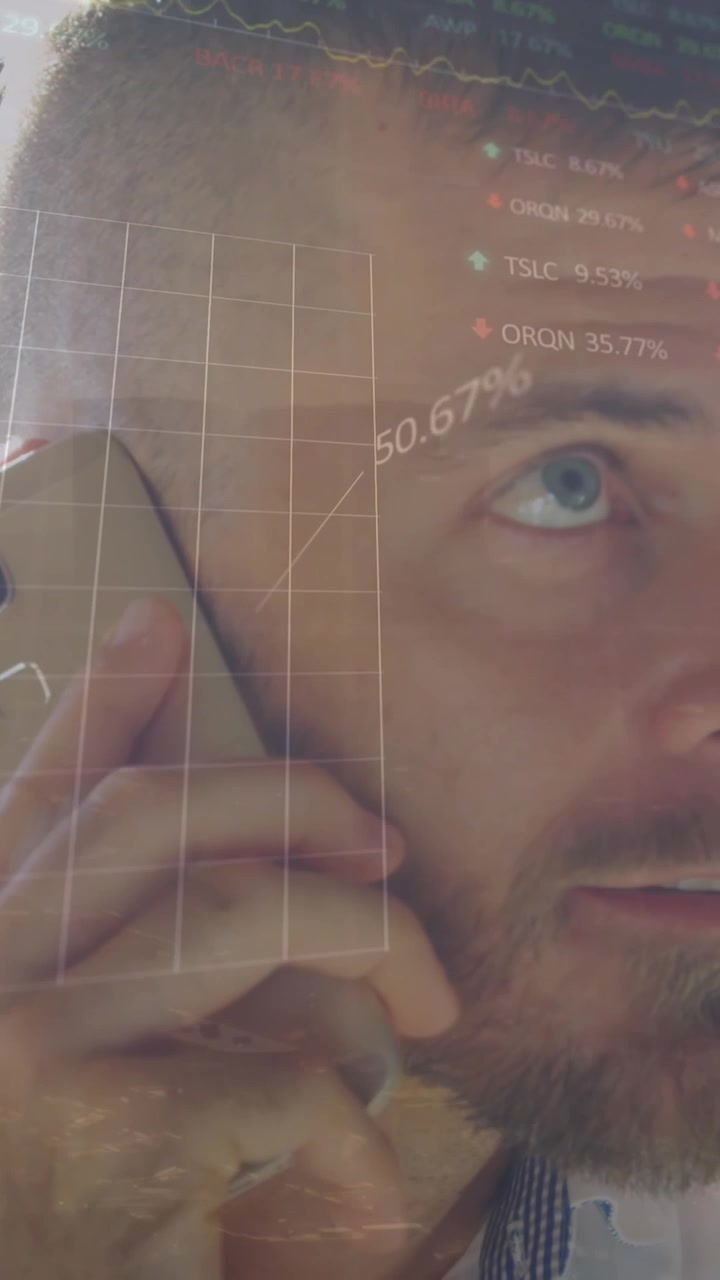 Animation of stock market data processing against caucasian man talking on smartphone at office