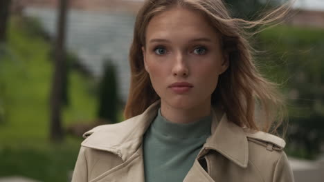 caucasian woman looking at the camera outdoors.