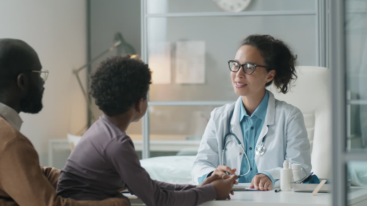 Female Pediatrician Giving Consultation to African American Kid and His Dad