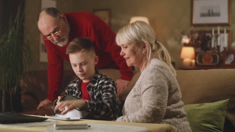 grandparents helping a teenager with a vr headset
