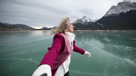 couple skating together on a frozen lake