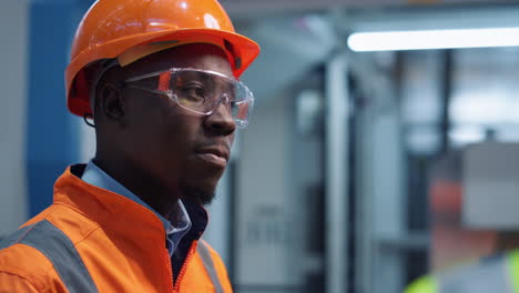 man engineer shaking head wearing safety uniform at modern factory closeup