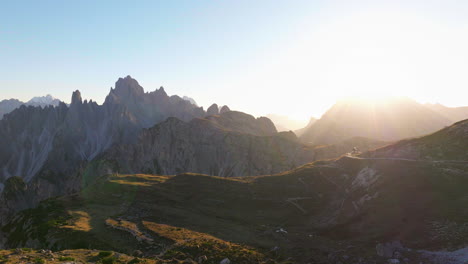 sunrays across south tyrol tre cime dolomites mountain landscape aerial view orbiting stunning extreme terrain